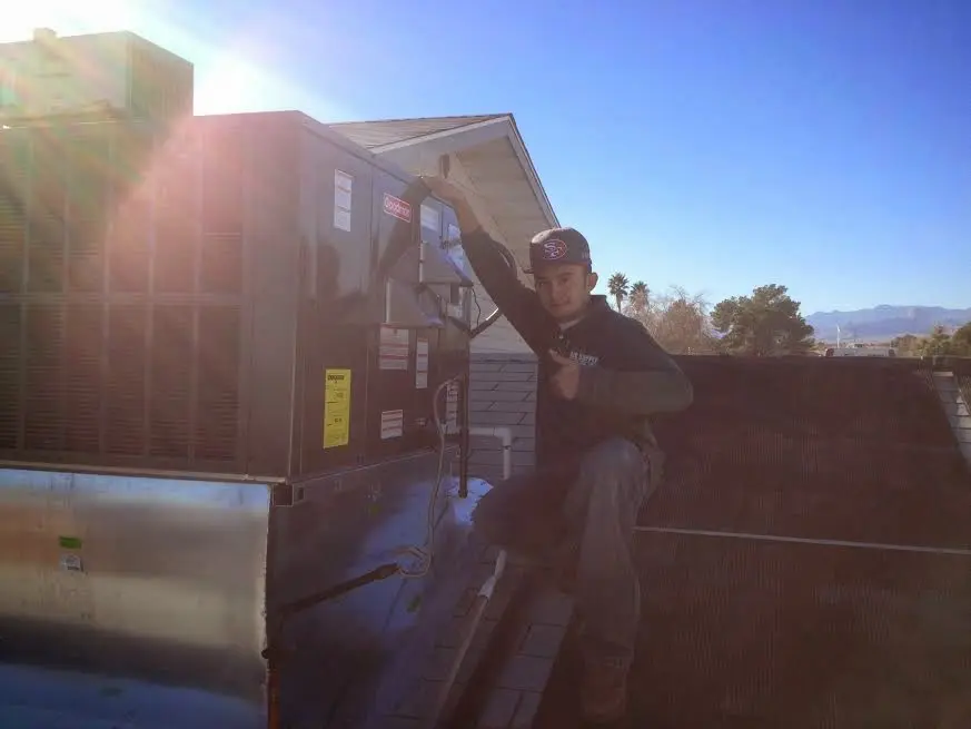 HVAC technician performing AC Tune-Up on a rooftop unit in Connellsville
